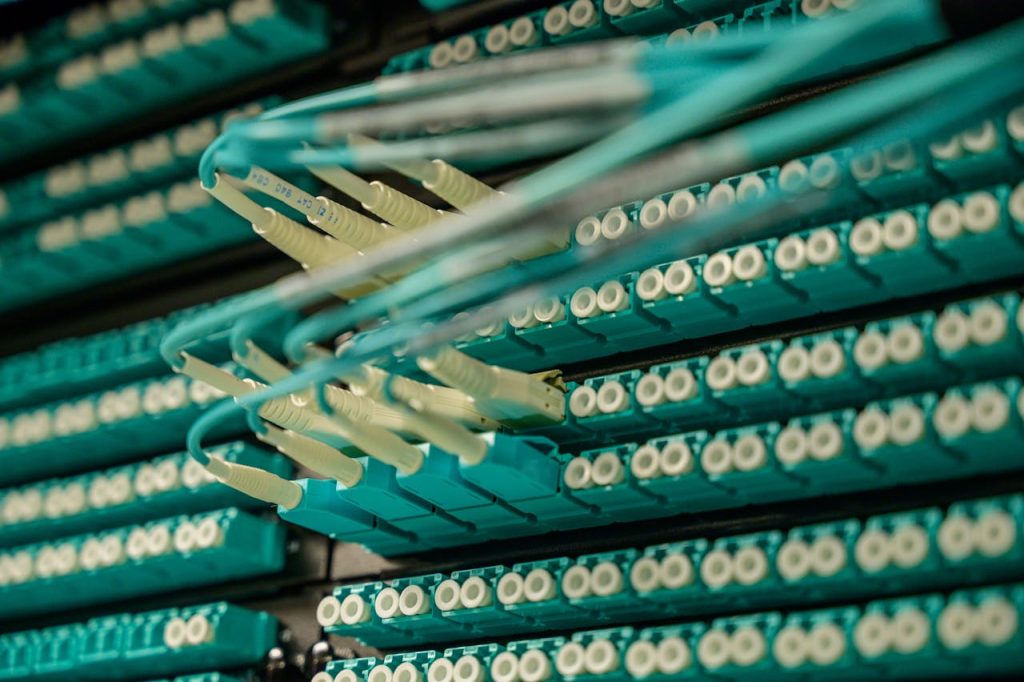 pexels-photo-2420212 Detailed view of fiber optic cables connected to a server rack, showcasing modern technology.